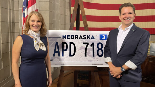First Lady Susanne Shore and Drew Davies unveil the Nebraska License Plate designed by Oxide